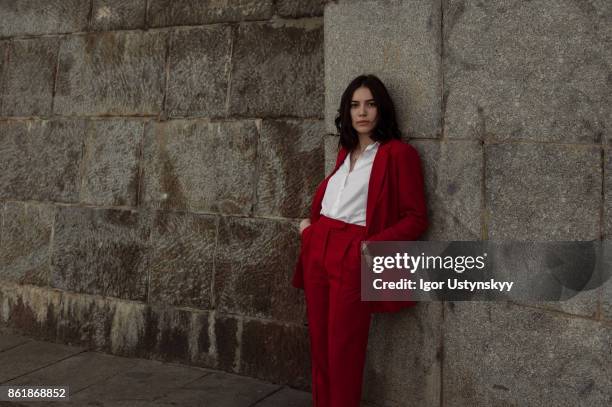 woman in red pantsuit  walking in the city - pant suit stock pictures, royalty-free photos & images