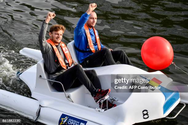 Belgian tennis players David Goffin and Steve Darcis gesture during the European pedalo cup, a pedalo match between the two finalists of the Davis...
