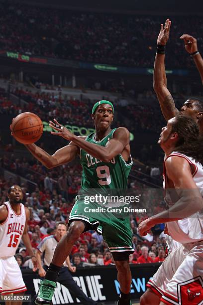 Rajon Rondo of the Boston Celtics passes against Joakim Noah and Tyrus Thomas of the Chicago Bulls in Game Three of the Eastern Conference...