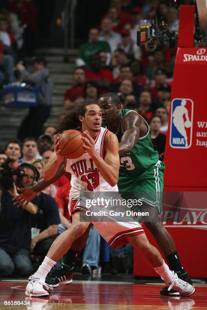 Joakim Noah of the Chicago Bulls posts up against Kendrick Perkins of the Boston Celtics in Game Three of the Eastern Conference Quarterfinals during...