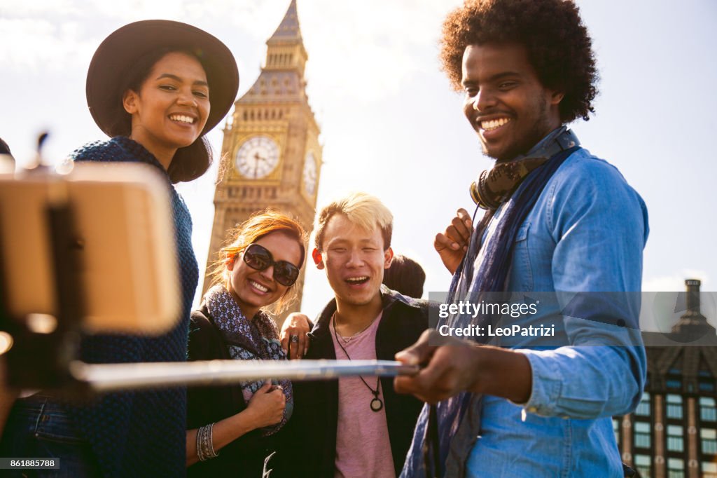 Ulti ethnic group of friends taking a selfie with BigBen in Central London