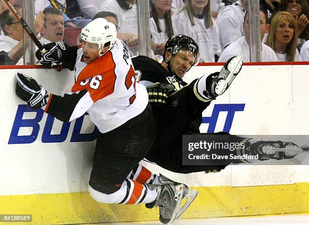 Philippe Boucher of the Pittsburgh Penguins collides with Darroll Powe of the Philadelphia Flyers during Game Five of the Eastern Conference...