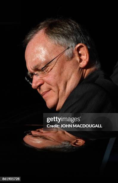 Lower Saxony's State Premier Stephan Weil, winner of regional elections in his north-western federal state, reflects in the roof of his car as he...