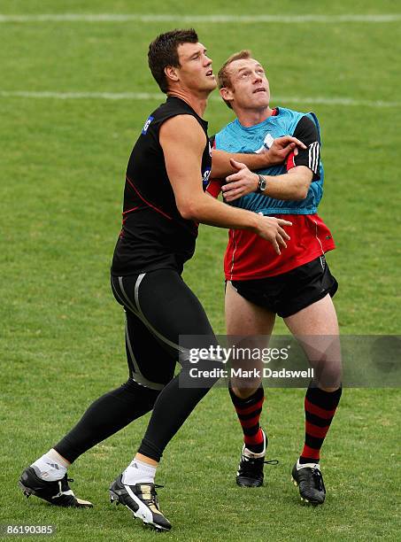 David Hille of the Bombers contests a ball up with assistant coach Adrian Hickmott during the Essendon Bombers AFL training session at Windy Hill on...