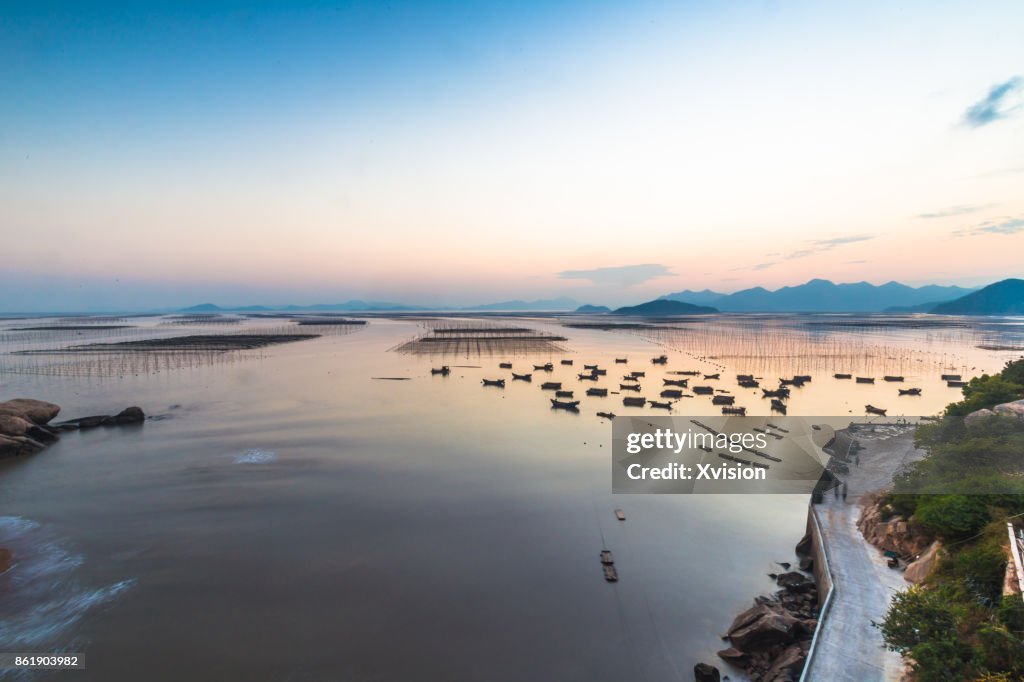 Sunset in the sea with lots of boats in Xiapu