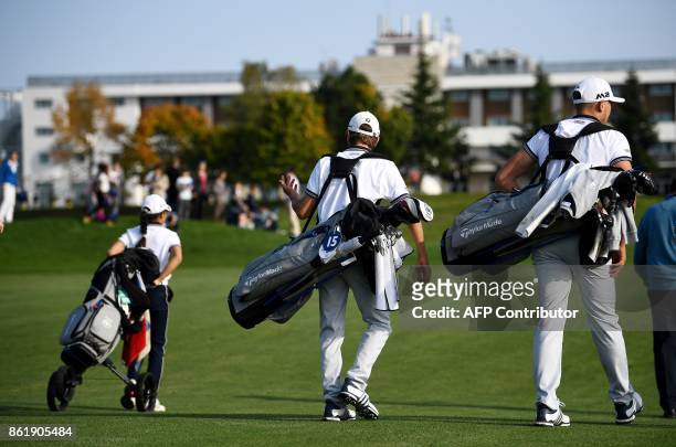 People walk on a green during the 2018 Ryder Cup media day on october 16, 2017 at the Golf National in Guyancourt, near Paris, the venue of the...