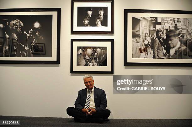 French photographer Jean-Marie Perier poses in front of pictures of Bob Dylan the Beatles , the Rolling Stones and Mick Jagger before opening night...