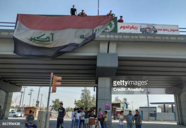 People cover the boards hang by Iraqi Kurdish Regional Government for Illegitimate independence referendum with Iraqi flag as Iraqi Army members...