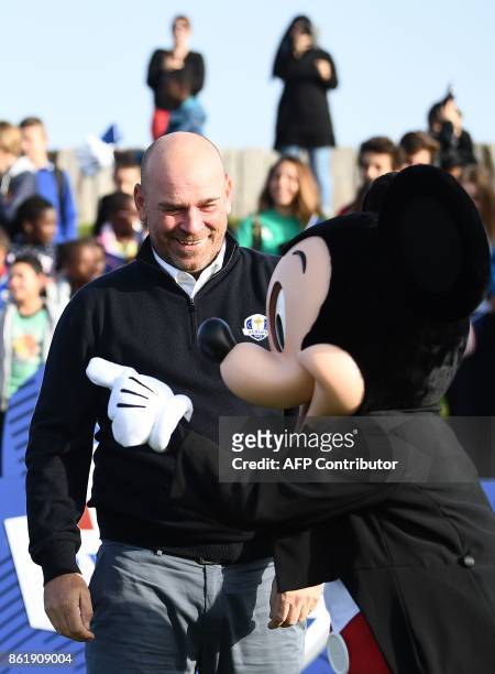 Europe's Ryder Cup captain Thomas Bjorn jokes with Mickey Mouse mascot during the 2018 Ryder Cup media day on October 16, 2017 at the Golf National,...