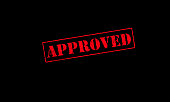 approved rubber stamp on a black background