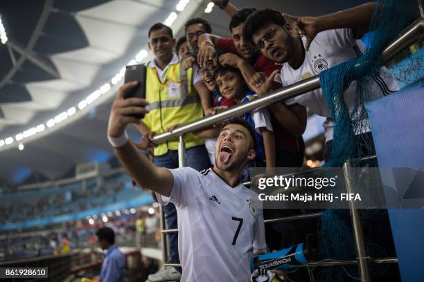 Sahverdi Cetin of Germany poses with a fans after winning the FIFA U-17 World Cup India 2017 Round of 16 match between Columbia and Germany at...