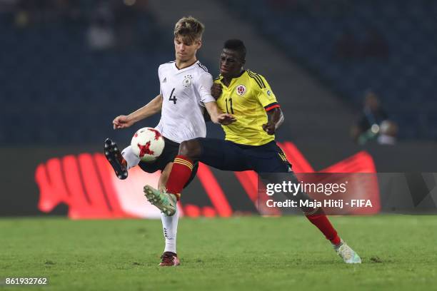 Juan Penaloza of Colombia and Dominik Becker of Germany battle for the ball during the FIFA U-17 World Cup India 2017 Round of 16 match between...