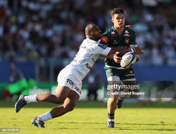 Matt Toomua of Leicester off loads the ball as Joe Rokococko tackles during the European Rugby Champions Cup match between Racing 92 and Leicester...