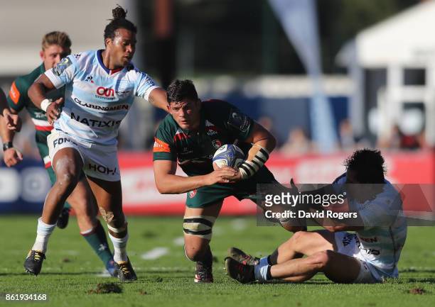 Mike Williams of Leicester is tackled by Teddy Thomas and Henry Chavancy during the European Rugby Champions Cup match between Racing 92 and...