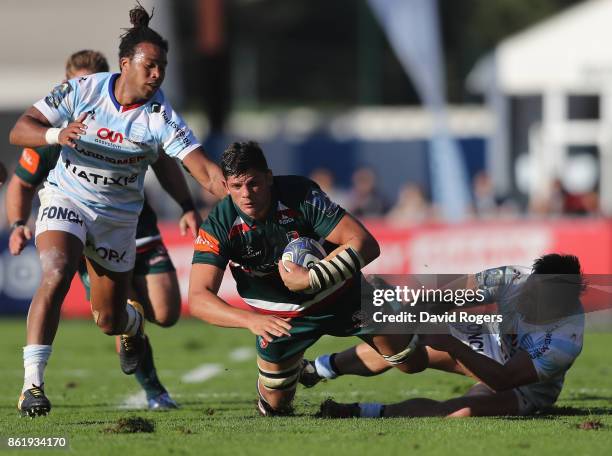 Mike Williams of Leicester is tackled by Teddy Thomas and Henry Chavancy during the European Rugby Champions Cup match between Racing 92 and...