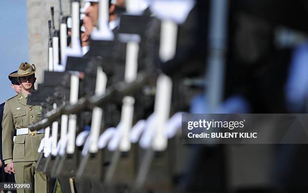 Turkish and Australian soldiers stand to attention during the ceremony celebrating the 94th anniversary of Anzac Day in Canakkale on April 24, 2009....