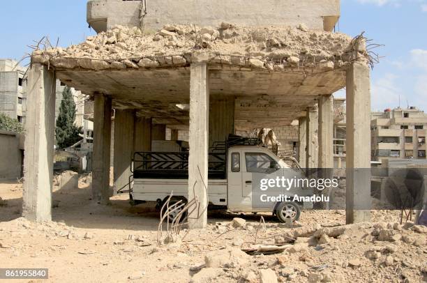 Debris of damaged buildings are seen after Assad regime's airstrikes hit residential areas of the de-conflict zone in Ein Tarma town of Eastern...