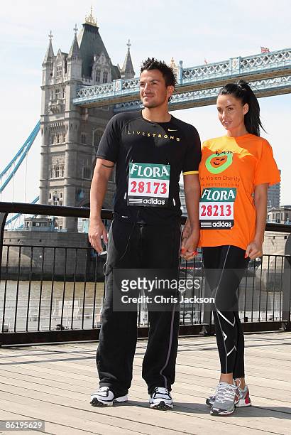 Katie Price poses for a photograph with her husband Peter Andre during a 'Celebrity Marathon Runners' photocall outside Tower Bridge Hotel on April...