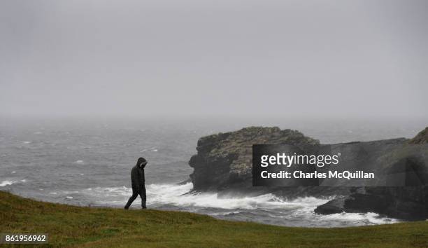 Man walks along St. John's Point during Hurricane Ophelia on October 16, 2017 in Donegal, Ireland. The hurricane hit the north west coast of Ireland...