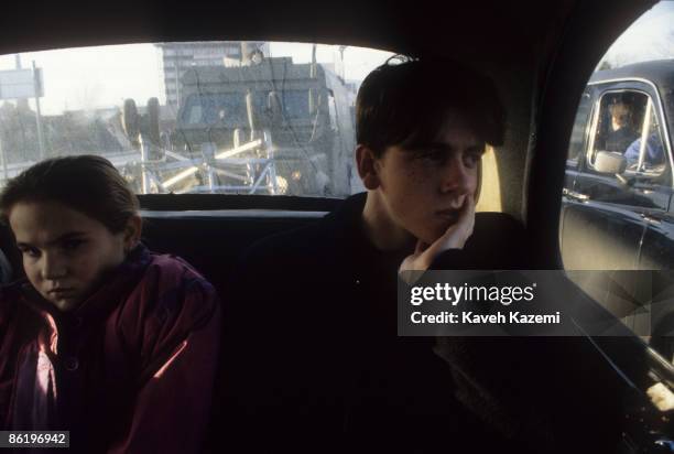 British armoured vehicle seen through the back window of a black cab used to shuttle passengers in Catholic residential areas of west Belfast, 28th...