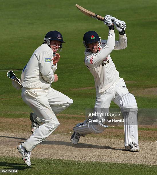 Francois Du Plessis of Lancashire smashes a boundary as Ed Joyce of Sussex takes evasive action during the LV County Championship Division One match...