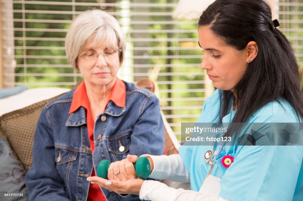 Senior adult woman and home healthcare nurse, physical therapist.