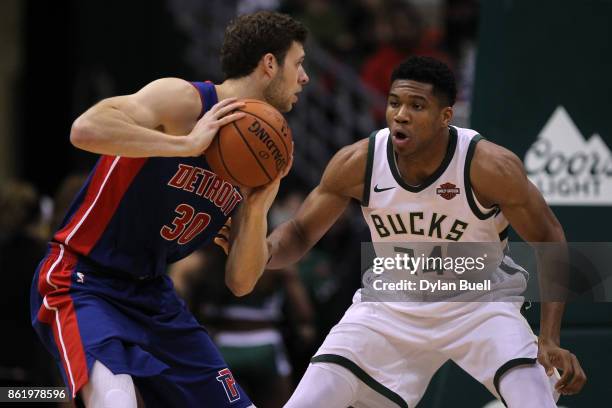 Giannis Antetokounmpo of the Milwaukee Bucks guards against Jon Leuer of the Detroit Pistons in the first quarter during a preseason game at BMO...