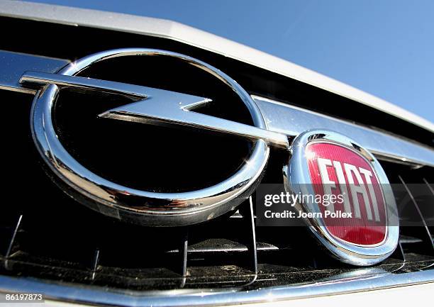 In this Photo Illustration a Fiat logo is seen at an Opel car on the ground of a car dealer on April 24, 2009 in Morrege, Germany. According to...