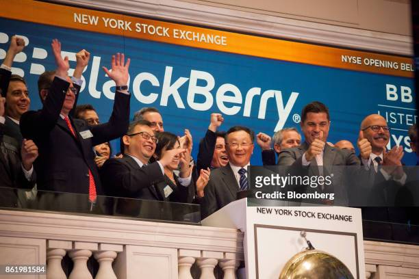 John Chen, executive chairman and chief executive officer of BlackBerry Ltd., center, rings the opening bell during the company's listing migration...