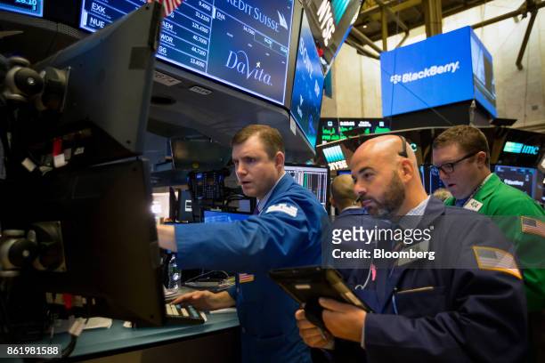 Traders work on the floor of the New York Stock Exchange in New York, U.S., on Monday, Oct. 16, 2017. The dollar strengthened and Treasuries fell...