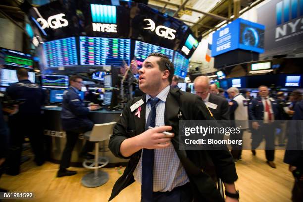 Trader works on the floor of the New York Stock Exchange in New York, U.S., on Monday, Oct. 16, 2017. The dollar strengthened and Treasuries fell...