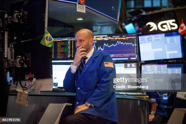 Trader works on the floor of the New York Stock Exchange in New York, U.S., on Monday, Oct. 16, 2017. The dollar strengthened and Treasuries fell...