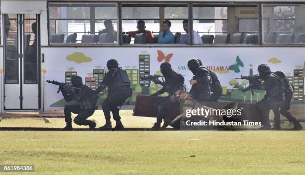 National Security Guard commandos display their skills during a function to celebrate the 33rd NSG Raising Day, at Manesar campus, on October 16,...