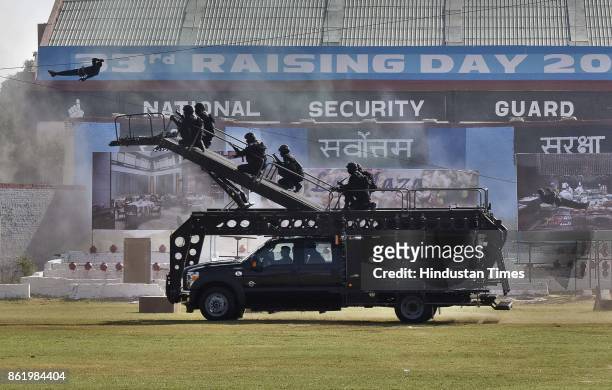 National Security Guard commandos display their skills during a function to celebrate the 33rd NSG Raising Day, at Manesar campus, on October 16,...