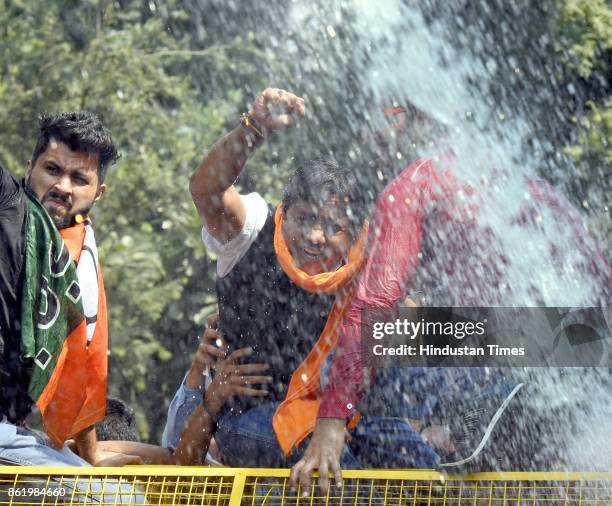 Delhi BJP Yuva Morcha President Sunil Yadav with youth activists protests against hike in Metro fare by Delhi Government, near Delhi CM Arvind...