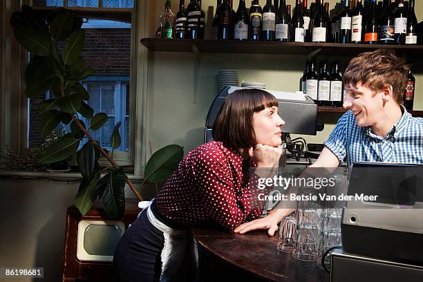 waitress and barman flirting in restaurant. - flirting stock pictures, royalty-free photos & images