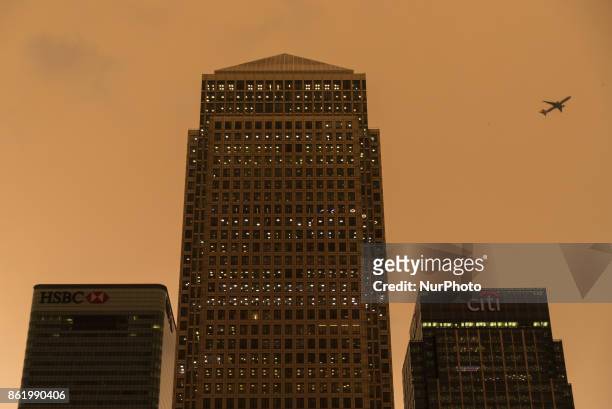 Darkened sky over London is pictured at financial district of Canary Wharf, London on October 16, 2017. The darkening is caused by warm air and dust...