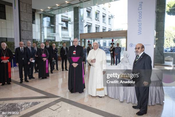 General director José Graziano da Silva and Pope of the Catholic Church, Pope Francis stand in front of a marble statue, depicting the "Aylan Kurdi"...