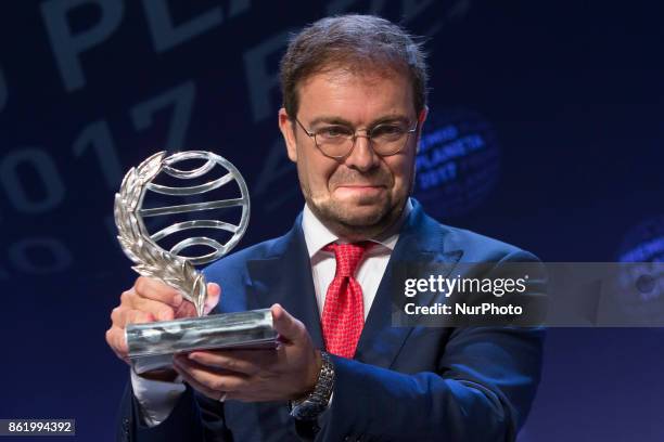 Spanish writer Javier Sierra smiles as he poses after receiving the Spain's 2017 'Premio Planeta' award for his book 'El Fuego Invisible' in...