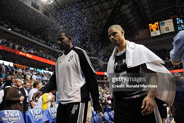 Michael Finley and Ime Udoka of the San Antonio Spurs walks off the court after a 88-67 loss against the Dallas Mavericks in Game Three of the...