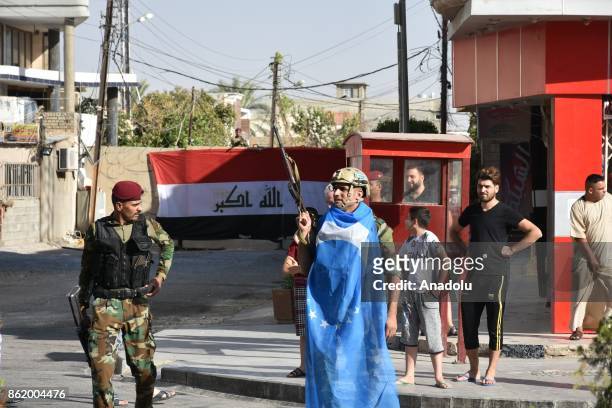 Turkmens support Iraqi forces by securing their districts and buildings with weapons after Iraqi forces retake the city's control from Peshmerga...