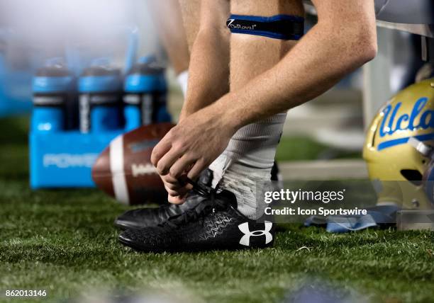 Bruins players adjusts his Under Armour cleats during the college football game between the UCLA Bruins and the Arizona Wildcats on October 14 at...