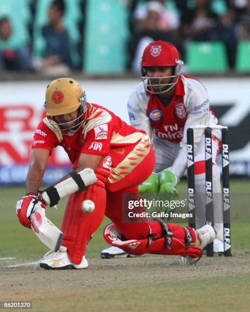 Rahul Dravid plays a sweep shot as Kumara Sangakarra keeps wicket during IPL T20 match between Royal Challengers Bangalore and Kings XI Punjab at...