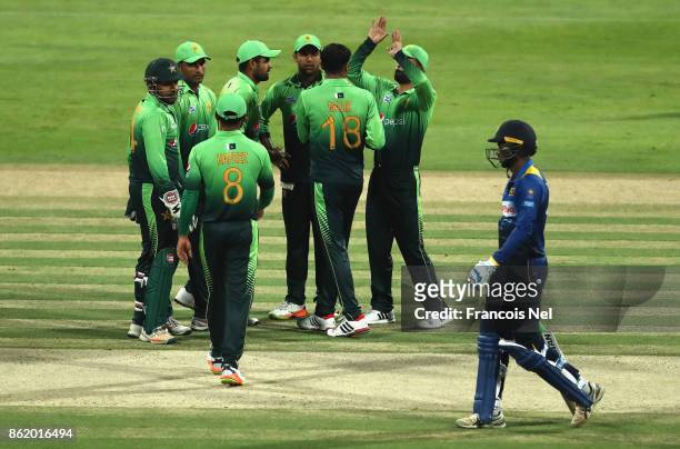 Lahiru Thirimanne of Sri Lanka leaves the field after being dismissed by Sohab Malik of Pakistan during the second One Day International match...