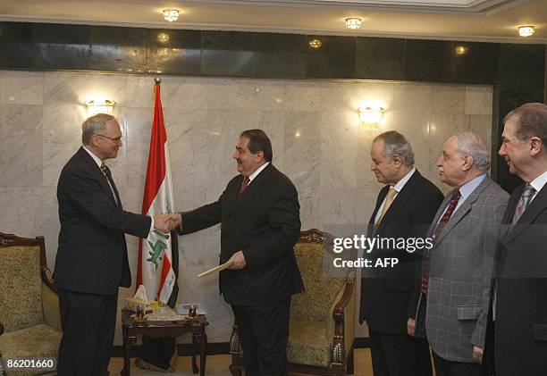 Diplomat Christopher Hill shakes hands with Iraqi Foreign Minister Hoshyar Zebari after presenting his credentials at the Foreign Ministry in Baghdad...