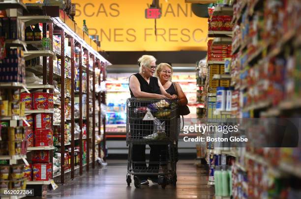 Sisters Cruz Sanchez, left, of Mattapan, and Frances Rosado, of Dorchester, shop at Tropical Foods in the Roxbury neighborhood of Boston on Aug. 22,...