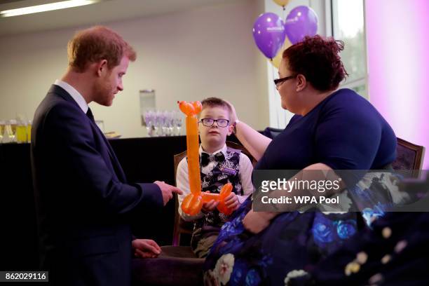 Patron of WellChild Prince Harry meets Finley Green, aged 7, the winner of the Inspirational Child Award aged 4-6, with his mother Jennifer during a...