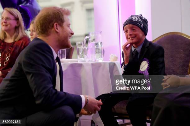 Patron of WellChild Prince Harry meets Marni Ahmed, aged 9 the winner of the Inspirational Child Award aged 7-10 with his mother Gulzeab during a...