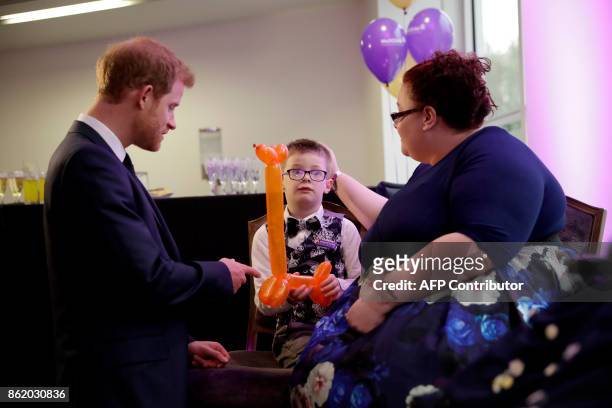 Britain's Prince Harry meets Finley Green, winner of the Inspirational Child Award aged 4-6, with his mother Jennifer, as he attends the WellChild...