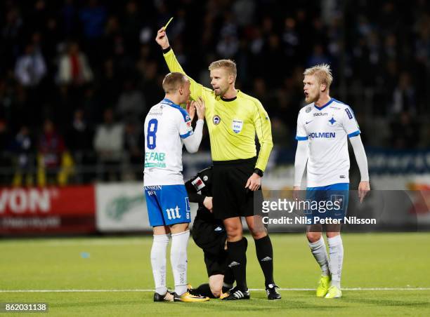 Gudmundur Thórarinsson of IFK Norrkoping is shown a yellow card by Glenn Nyberg, referee during the Allsvenskan match between IFK Norrkoping and...